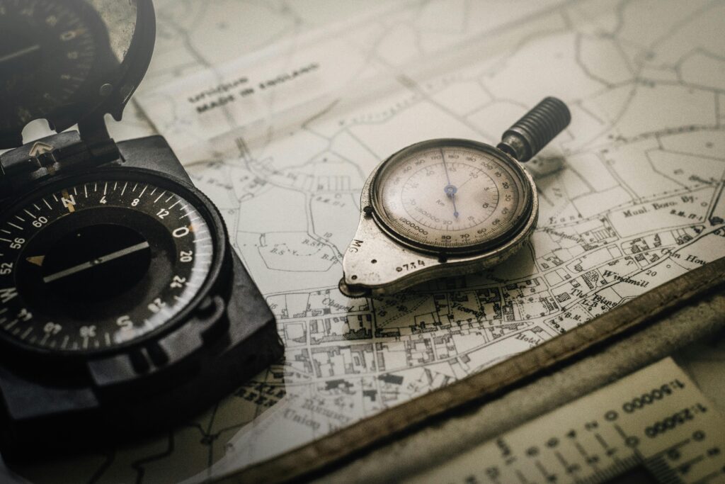 pexels-photo-1203808-1203808 A vintage compass and navigation instrument on an old map, showcasing precision tools for exploration.